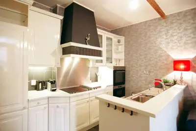 a kitchen with white cabinets and a stove top oven at Group Stay, 7 minutes away from Amsterdam! in Halfweg