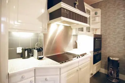 a kitchen with white cabinets and a counter top at Group Stay, 7 minutes away from Amsterdam! in Halfweg
