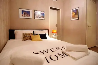 a bedroom with a white bed with a sign on it at Group Stay, 7 minutes away from Amsterdam! in Halfweg