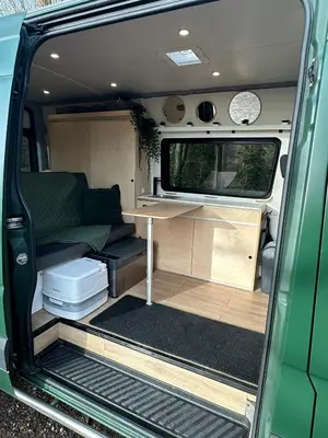 an open door of an rv with a table in it at Mercedes Sprinter Camper Arbor in Heiloo