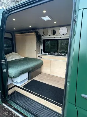 an open door of an rv with a bed in it at Mercedes Sprinter Camper Arbor in Heiloo