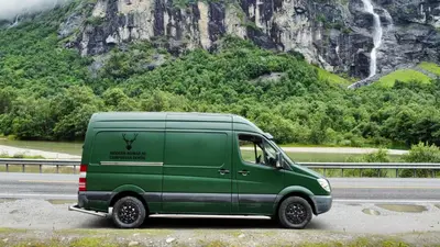 a green van parked on the side of a road at Mercedes Sprinter Camper Arbor in Heiloo