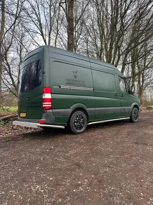 a green van parked in a parking lot at Mercedes Sprinter Camper Arbor in Heiloo