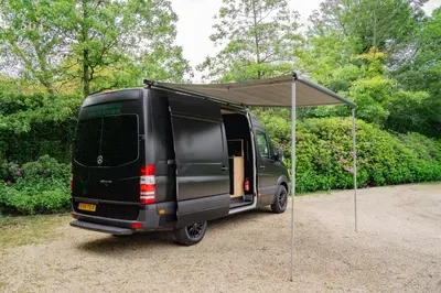 a black van with a tent on top of it at Mercedes Sprinter Camper FREYA in Heiloo
