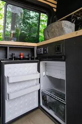 an open refrigerator in an rv at Mercedes Sprinter Camper FREYA in Heiloo