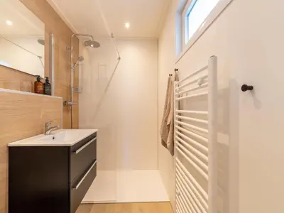 a bathroom with a sink and a shower at Holiday home in 't Groene Hart on the water in Oud-Ade