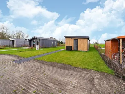 a home with a courtyard with a house at Holiday home in 't Groene Hart on the water in Oud-Ade