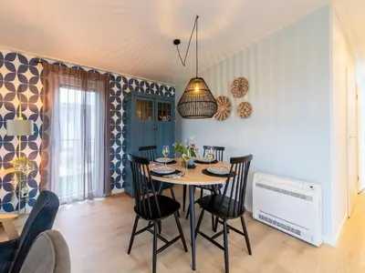 a dining room with a table and chairs at Holiday home in 't Groene Hart on the water in Oud-Ade