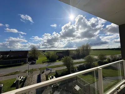 a view from the balcony of a building at Appartement 'Zeeblick' in Burgerbrug