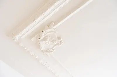 a white coffered ceiling with a white crown molding at Historic Canal House Apartment in Amsterdam