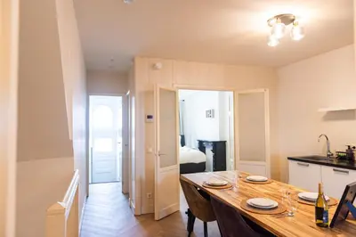 a kitchen and a dining room with a wooden table at Historic Canal House Apartment in Amsterdam