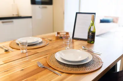 a table with two plates and a bottle of wine at Historic Canal House Apartment in Amsterdam