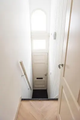 a hallway with a door and a window at Historic Canal House Apartment in Amsterdam