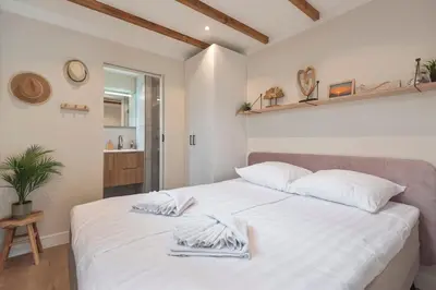 a bedroom with a white bed with towels on it at Beach House at C in Zandvoort