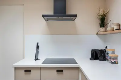 a white kitchen with a sink and a counter top at Beach House at C in Zandvoort