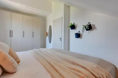 a bedroom with a bed with white walls at Meerzicht 61 - Luxury 4 person apartment in Uitgeest