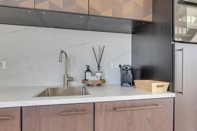 a kitchen with a sink and a counter top at Meerzicht 61 - Luxury 4 person apartment in Uitgeest