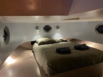 a bedroom with a bed with two pillows on it at Woonboot Josja in Amsterdam