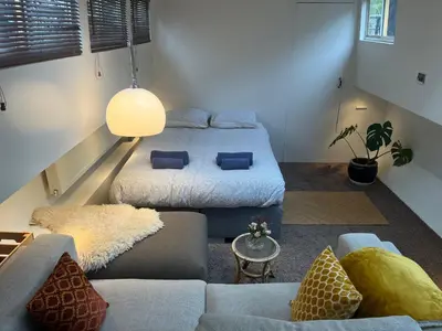 a living room with two beds and a couch at Woonboot Josja in Amsterdam