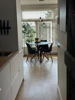 a dining room with a table and chairs in a kitchen at De schelp 71, Free parking in Zandvoort