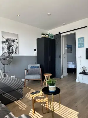 a living room with a couch and a table at De schelp 71, Free parking in Zandvoort