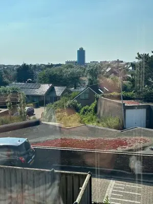 a car driving down a street in a parking lot at De schelp 71, Free parking in Zandvoort
