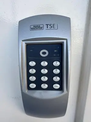 a remote control is attached to a wall at De schelp 71, Free parking in Zandvoort