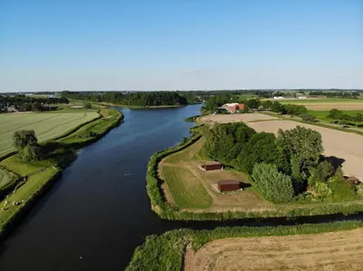 an aerial view of a river with trees and grass at De Meerkoet in Nieuwe-Niedorp