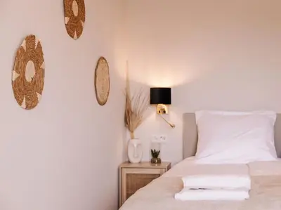 a bedroom with a white bed and a night stand at Ceebee - Free parking in Zandvoort