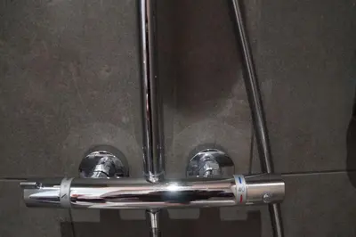 a close up of two metal pipes in a bathroom at natural green loft in Bergen