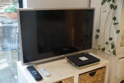 a flat screen tv sitting on top of a table at natural green loft in Bergen