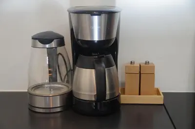 a coffee maker sitting on a table with a counter top at natural green loft in Bergen