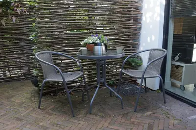 a table with two chairs and a table with a plant at natural green loft in Bergen