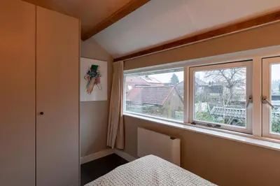 a bedroom with a window and a bed with a bedspread at Petitville in Austerlitz