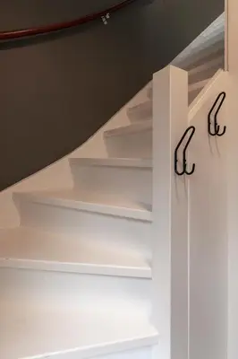 a staircase with white shelves in a room at Petitville in Austerlitz