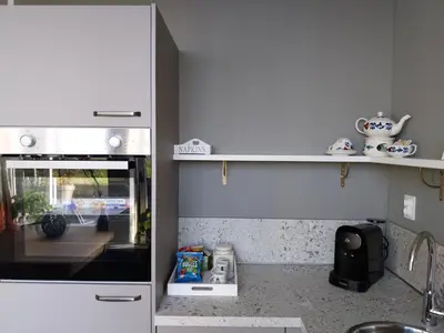 a kitchen with a stove and a counter top at Vakantiewoning Hem in Hem