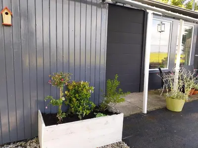 a planter with flowers in it next to a house at Vakantiewoning Hem in Hem