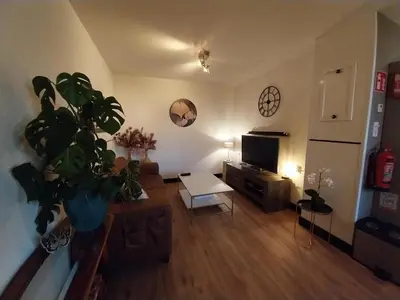 a living room with a couch and a table at Vakantiewoning Hem in Hem