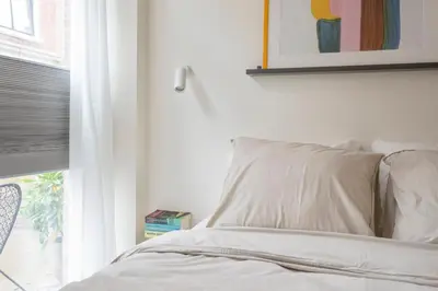 a bedroom with a bed with a window and a pillow at Studio Carlos in Haarlem