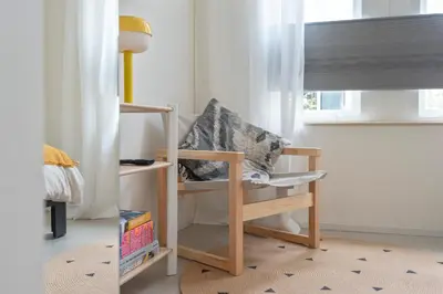 a childs room with a chair and a book shelf at Studio Carlos in Haarlem