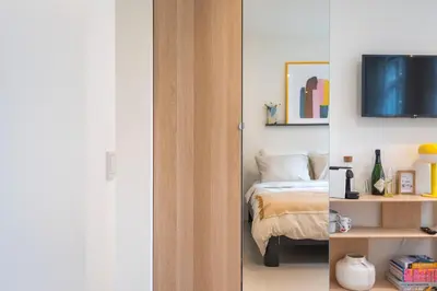 a bedroom with a bed and a tv on a wall at Studio Carlos in Haarlem
