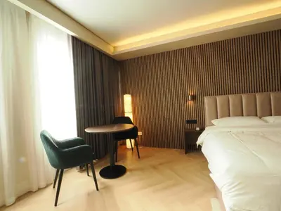 a hotel room with a bed and a table and chairs at Tung Hotel in Zeewolde