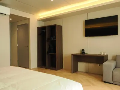 a bedroom with a bed and a television on the wall at Tung Hotel in Zeewolde