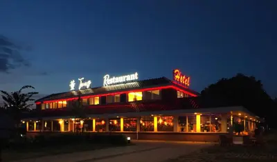 a building with a neon sign on top of it at Tung Hotel in Zeewolde