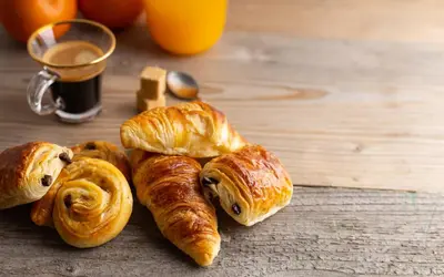 a group of croissants and other pastries on a table at Dijkstra Hotels in Bergen