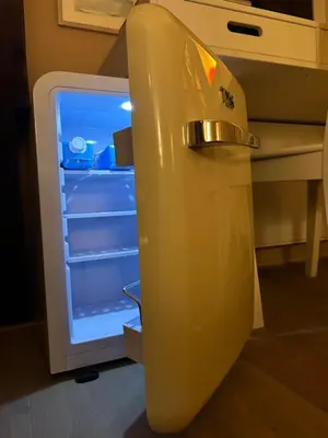 an empty refrigerator with its door open in a kitchen at Cozy room just outside Utrecht Center, calm & green in Utrecht