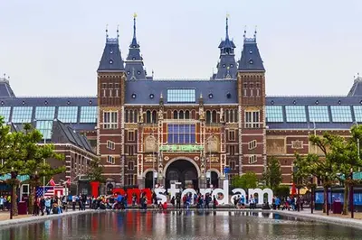 a large building with a fountain in front of it at Houseboat Tjonger NS003 in Monnickendam