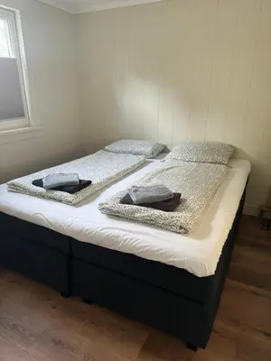 a bed with two pillows on top of it at Huisje Aangenaam in Dirkshorn