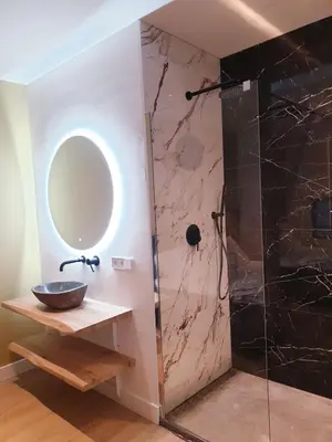 a bathroom with a sink and a mirror at Luxe stal appartement in Loenen aan de Vecht