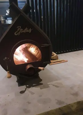 a wood fired pizza oven sitting on the floor at Luxe stal appartement in Loenen aan de Vecht